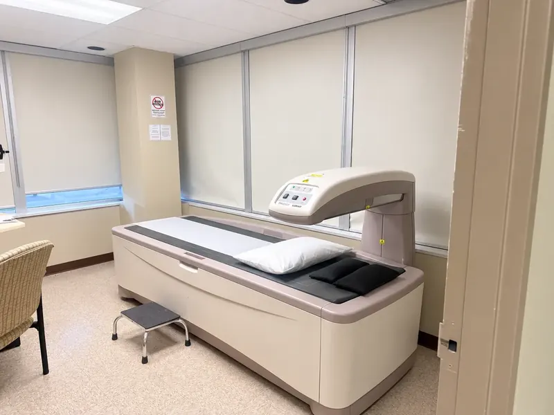 The bone density (BMD) room at 960 Lawrence Avenue West, with the scanning table, a pillow and a step stool
