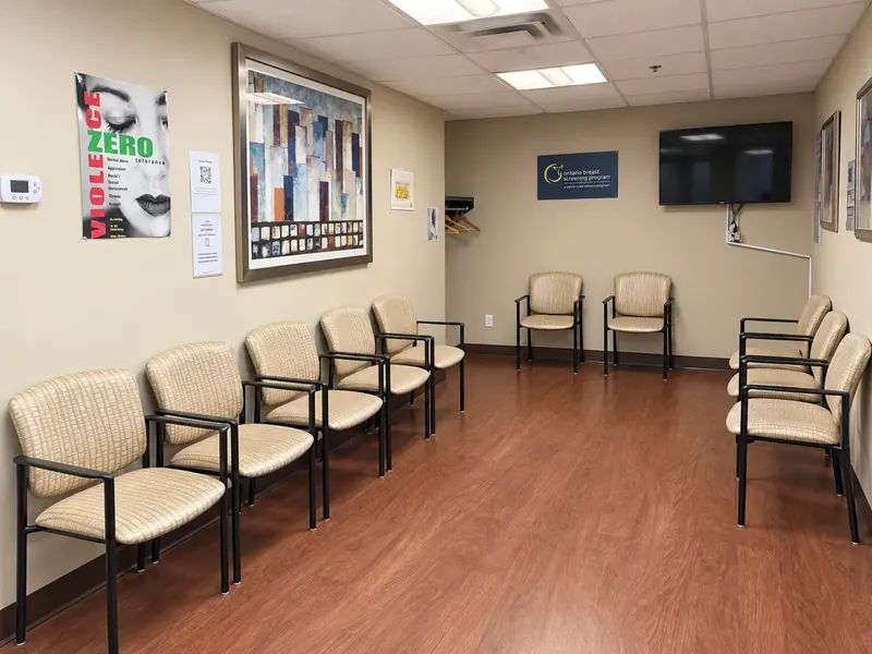 The waiting room at Bluewater Imaging, 960 Lawrence Avenue West, Suite 203: chairs along the walls, a television and the Ontario Breast Screening Program sign
